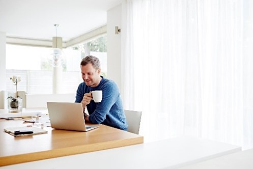 Man looking at his laptop at home